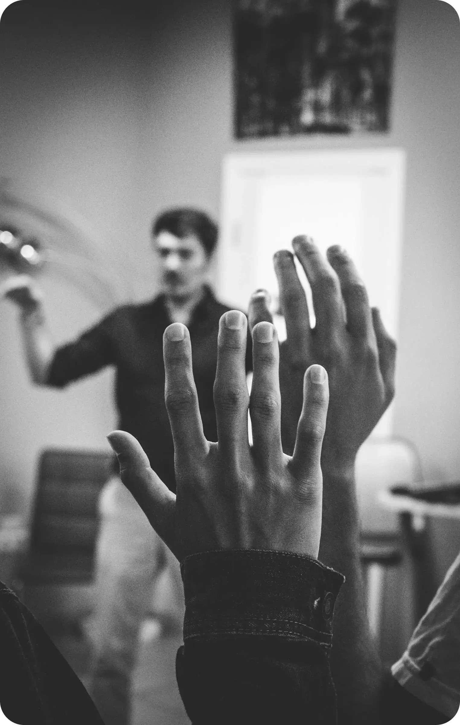 Person raising a hand during a RootBuilders session